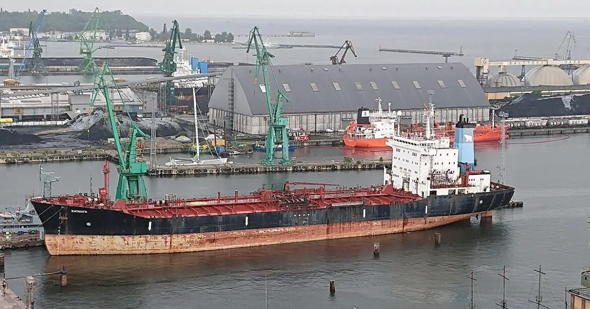 Abandoned Russian tanker on Polish shore with weeds.
