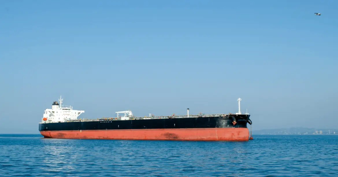 Three oil tankers engulfed in flames in the sea.