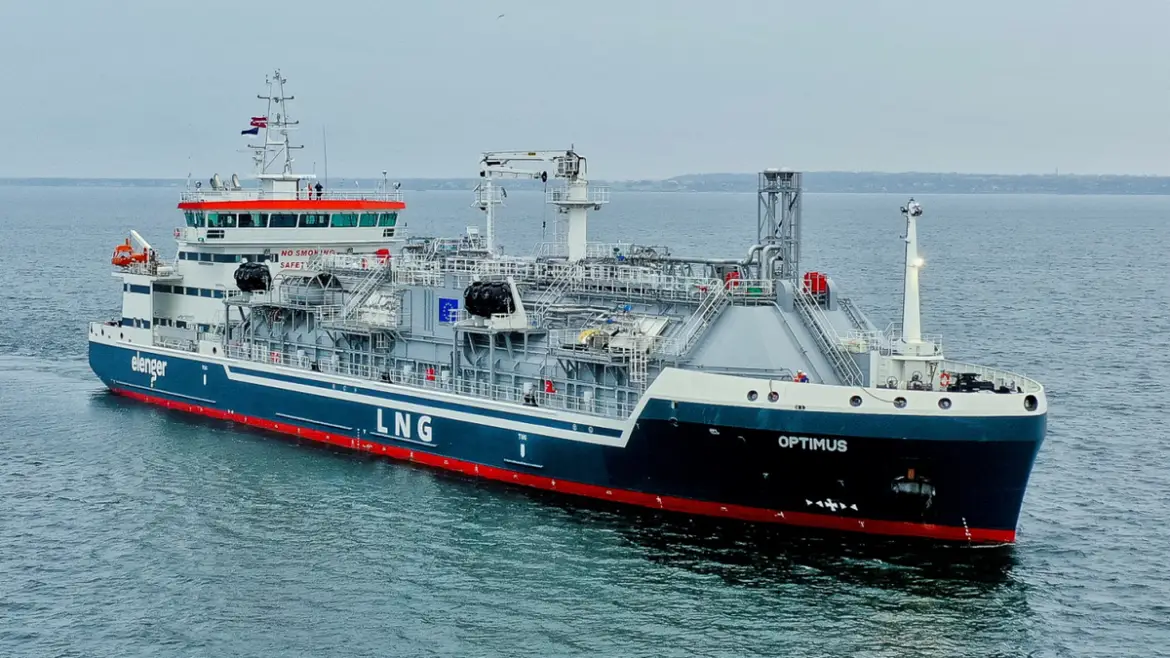 LNG bunker vessel on calm waters under a blue sky.