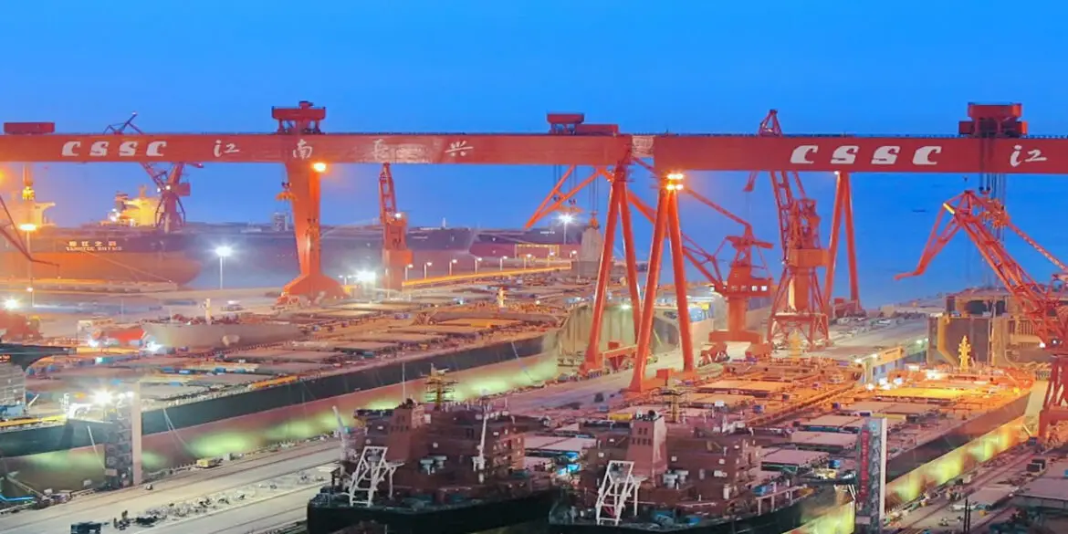 Shipyard in China with large vessels under construction.