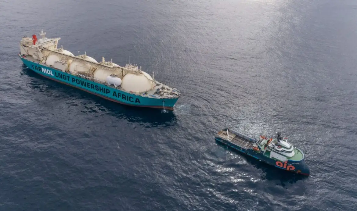 LNG cargo arrival at Senegal port, workers and ships.